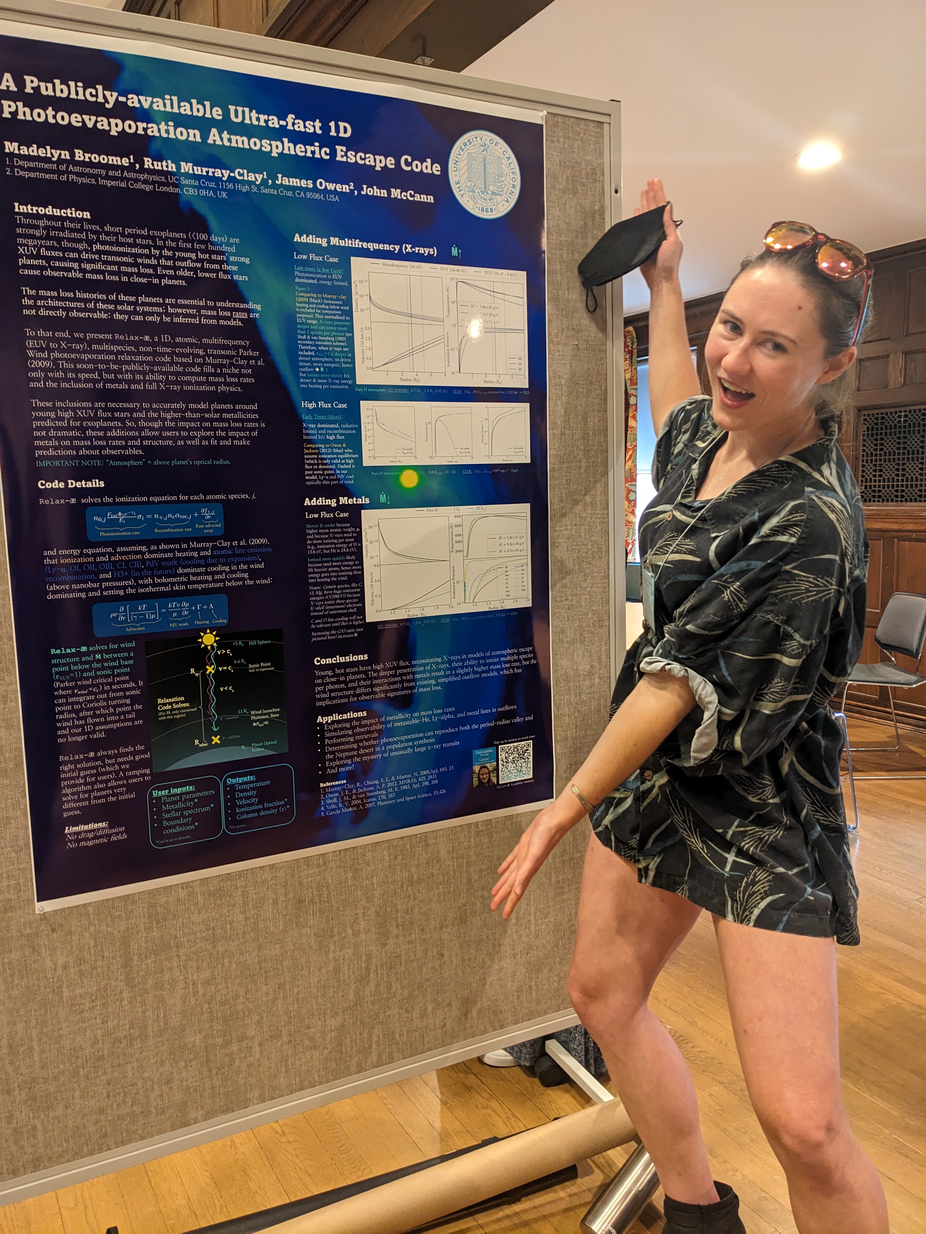 Madelyn enthusiastically gestures to a scientific poster.