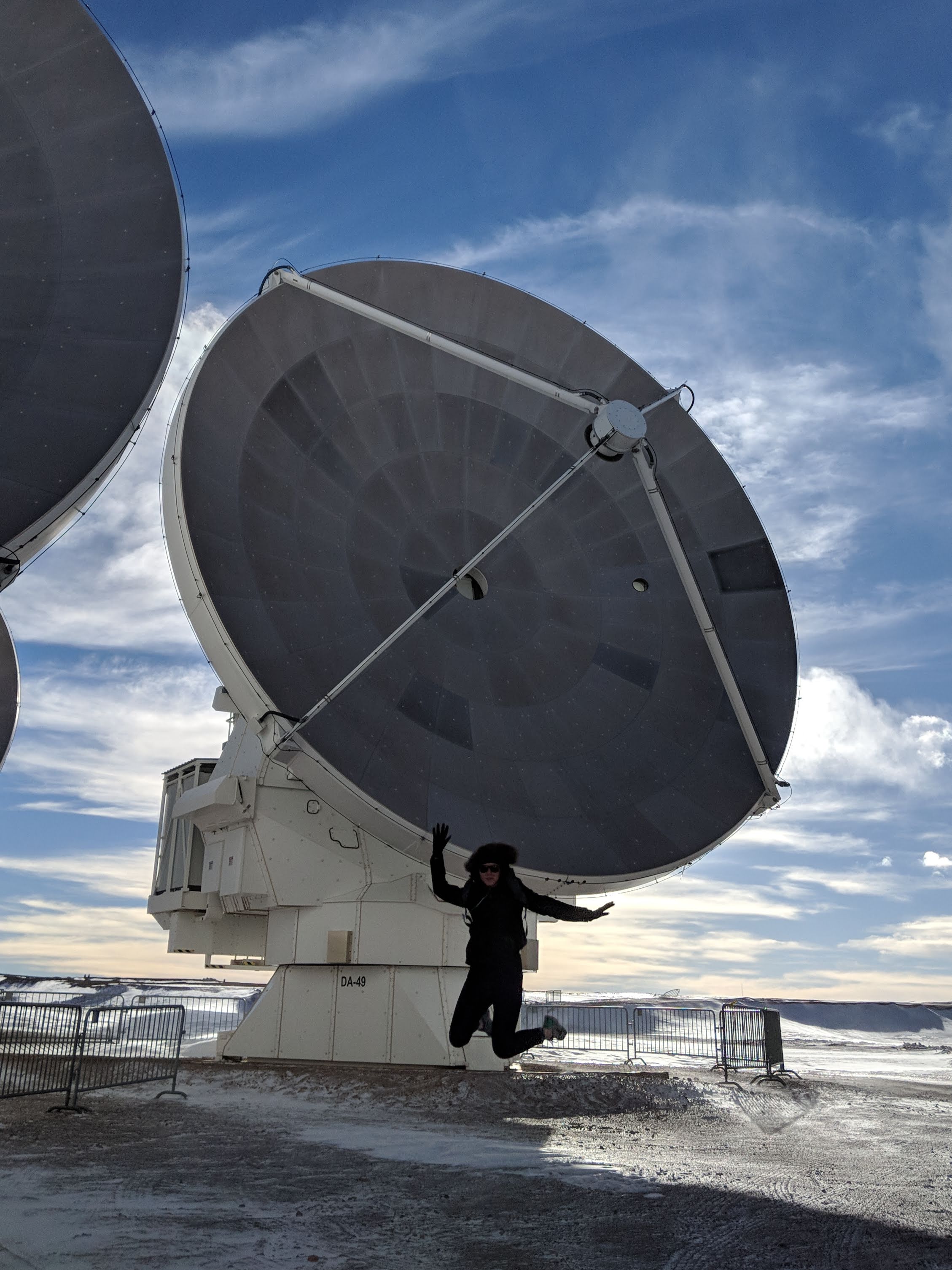 Madelyn jumps in front of ALMA dish in Chile.